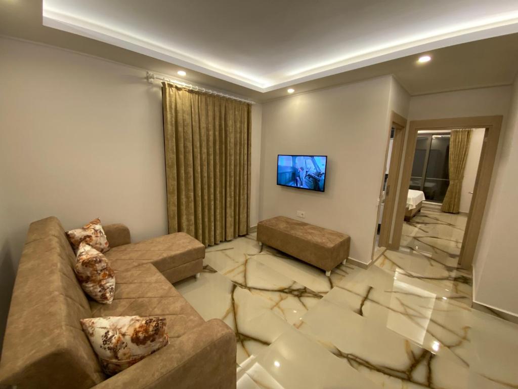 a living room with a couch and a flat screen tv at Huma Elite Hotel in Antalya