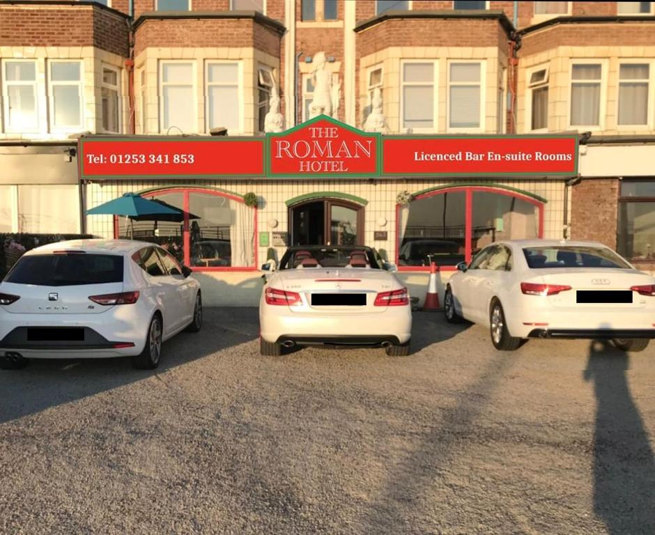 a group of cars parked in a parking lot at The Roman Hotel in Blackpool