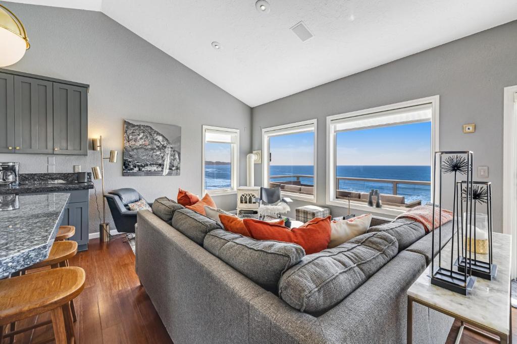 a living room with a large couch and a kitchen at Oceanside Oasis in Oceanside