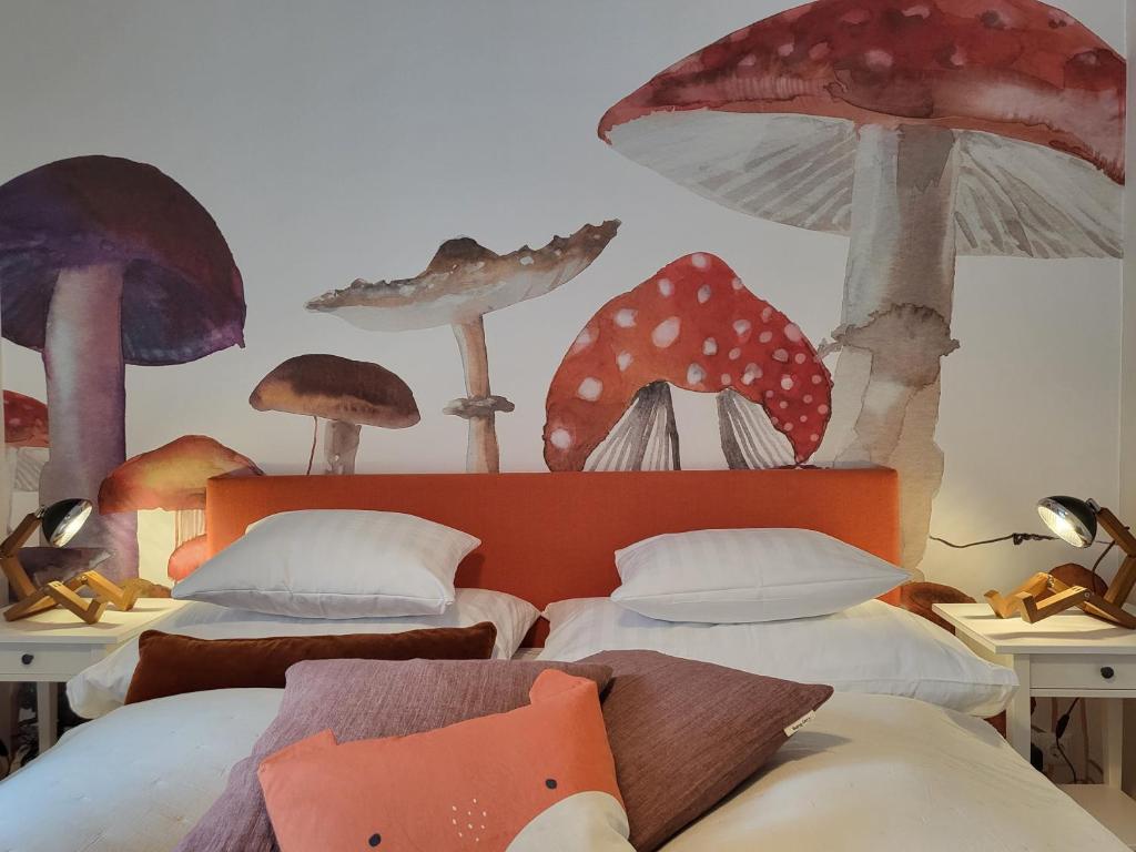 a bedroom with two beds with mushrooms on the wall at Orange Flat by GrazRentals highest standard & free parking in Graz