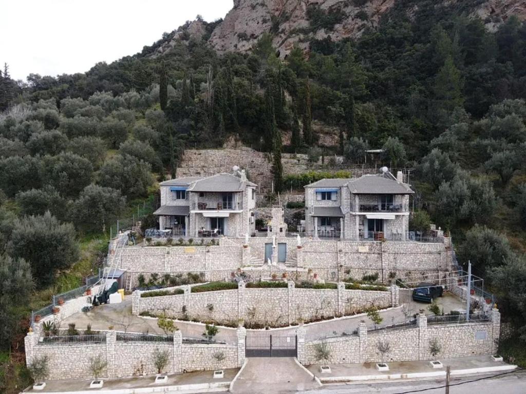 a large house on top of a mountain at Stone Maisonettes in Aigio