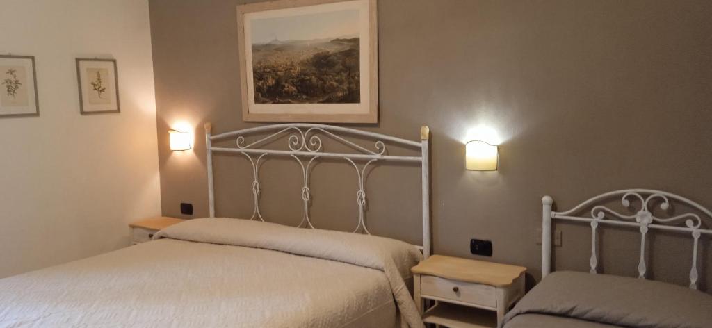 カーヴァ・デ・ティッレーニにあるB&B Da Vincenzoのベッドルーム1室(ベッド2台、壁に照明2つ付)