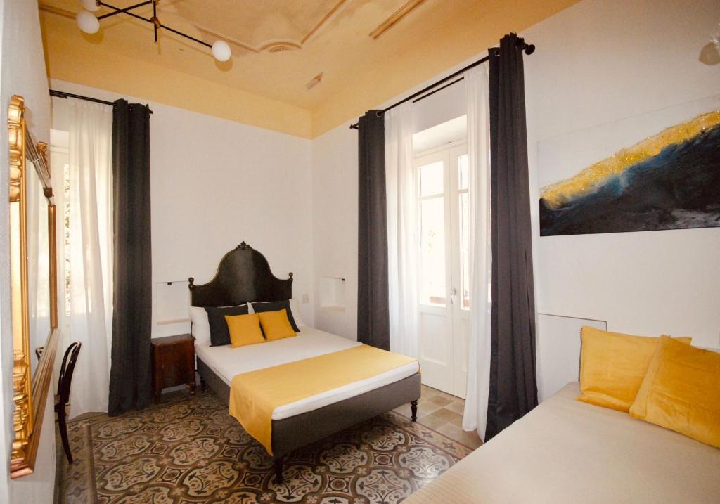 Ein Bett oder Betten in einem Zimmer der Unterkunft Su Zampillu Boutique Rooms Teulada