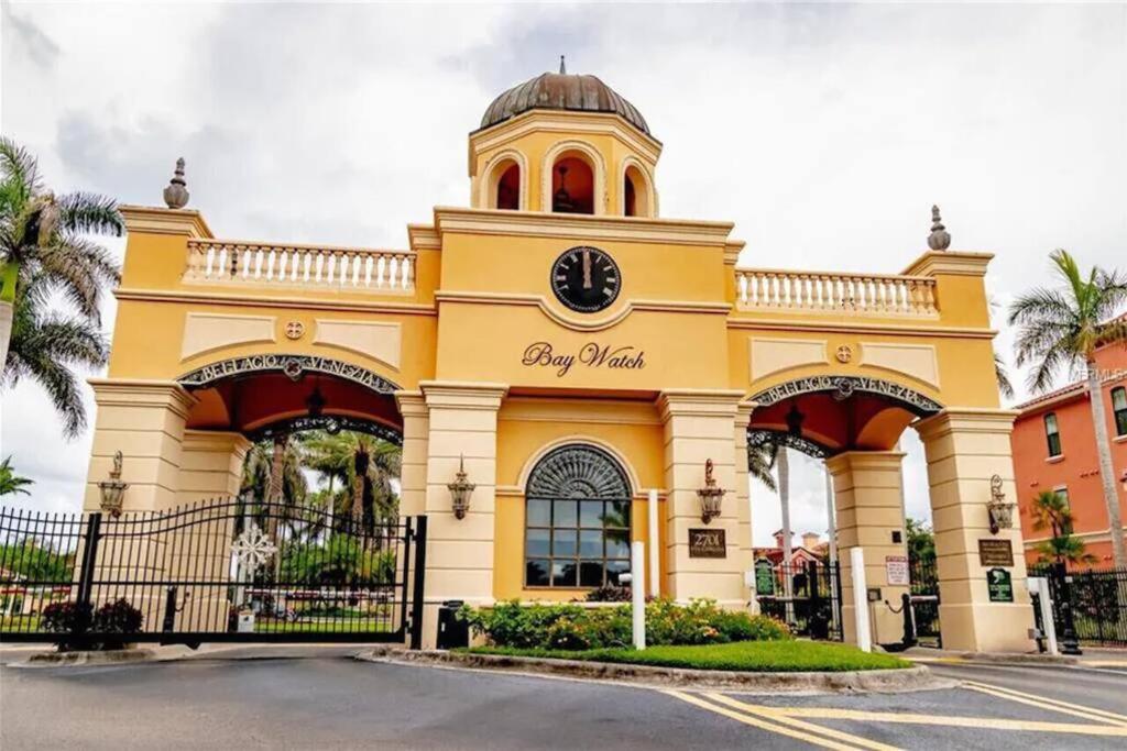 a large yellow building with a clock on it at Luxury 5 star Italian Resort Condo 2 bd 2 bath in Clearwater