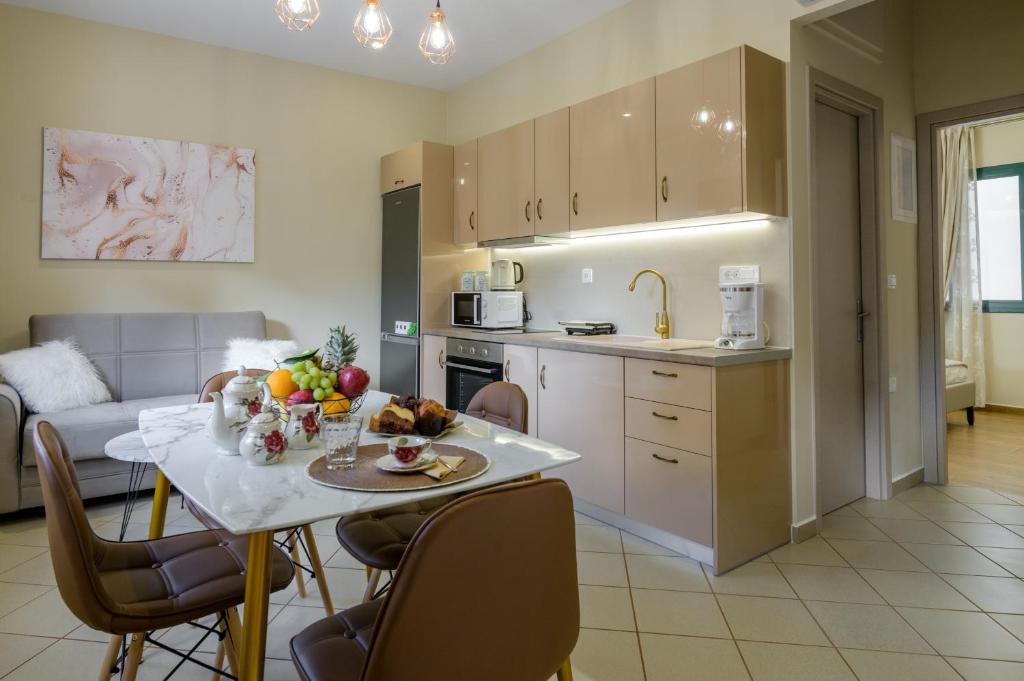 a kitchen and living room with a table with fruit on it at Nikola's & Joanna's apartments in Argostoli