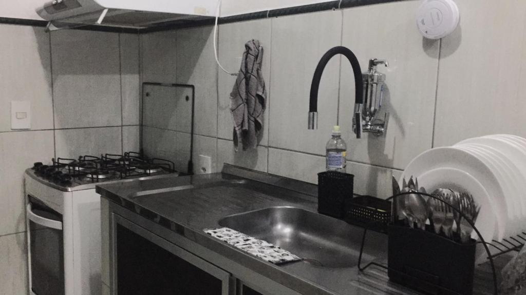 a kitchen with a sink and a stove at LOFT RIO in Rio de Janeiro