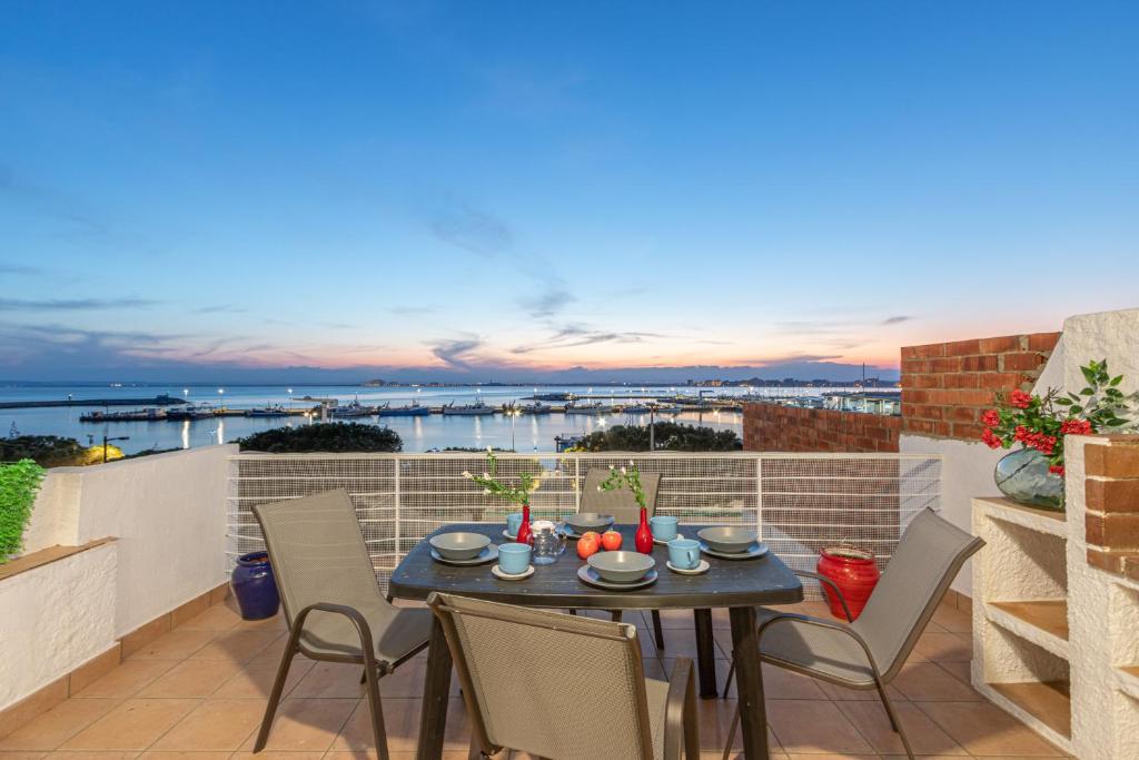 a patio with a table and chairs on a balcony at R30-CASA junto al MAR, PRECIOSAS VISTAS in Roses