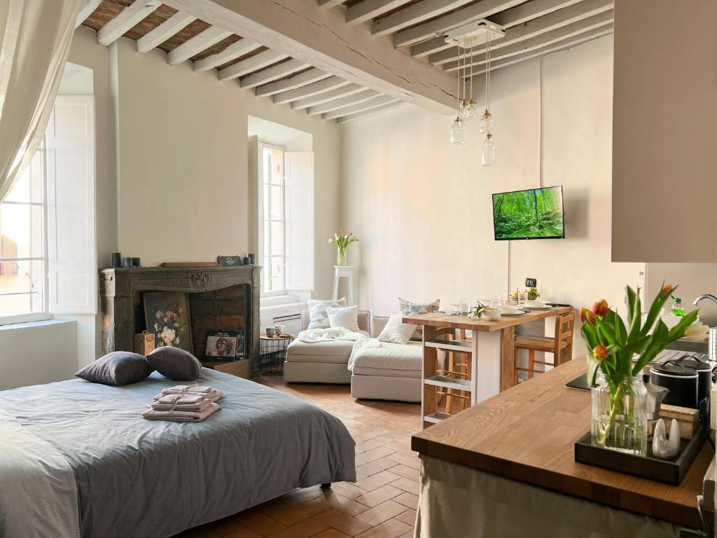 a living room with a bed and a kitchen at Lovely nest in Parma centro in Parma