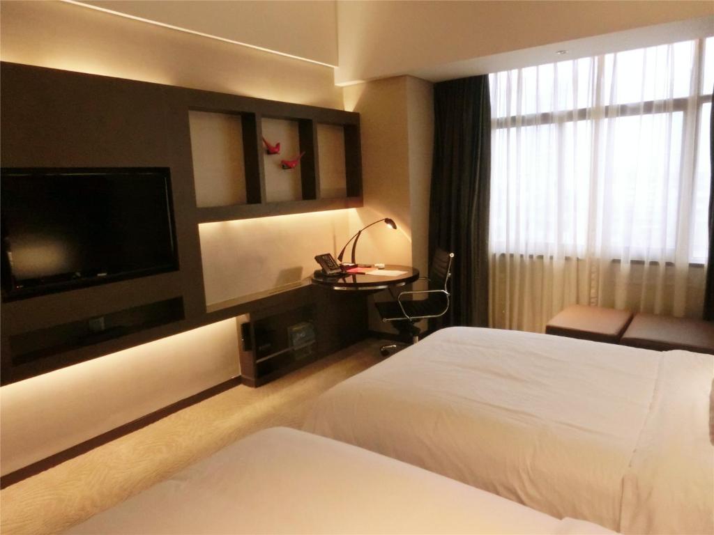 Postel nebo postele na pokoji v ubytování Guangzhou Baiyun Hotel