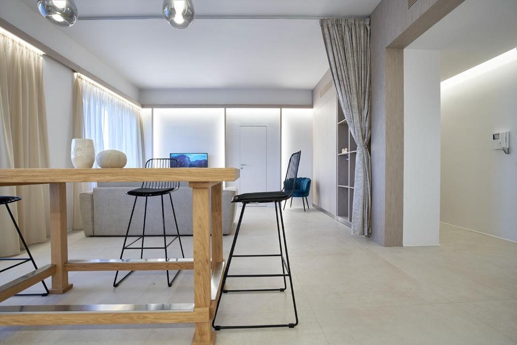 a living room with a wooden table and chairs at Five stars Florence luxury apartments in Florence