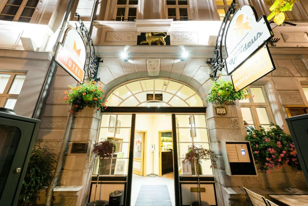 an entrance to a building with plants and flowers at Askania Hotel &amp; Brauhaus in Bernburg