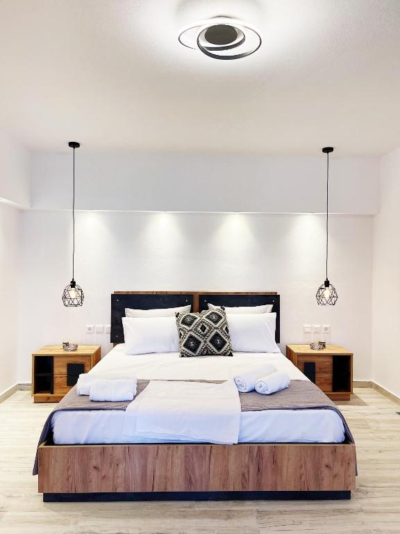 a bedroom with a large bed with two tables at Nostos home in Dhragoulás