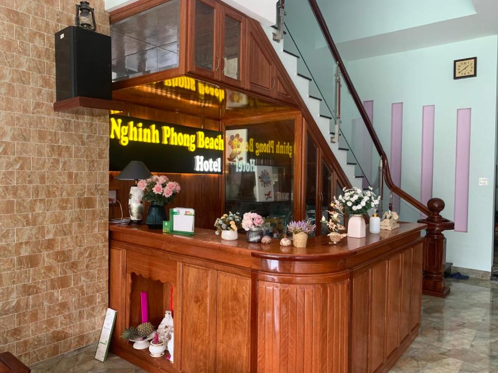 a restaurant with a counter with flowers on it at Khách sạn Nghinh Phong Beach Tuy Hòa in Tuy Hoa