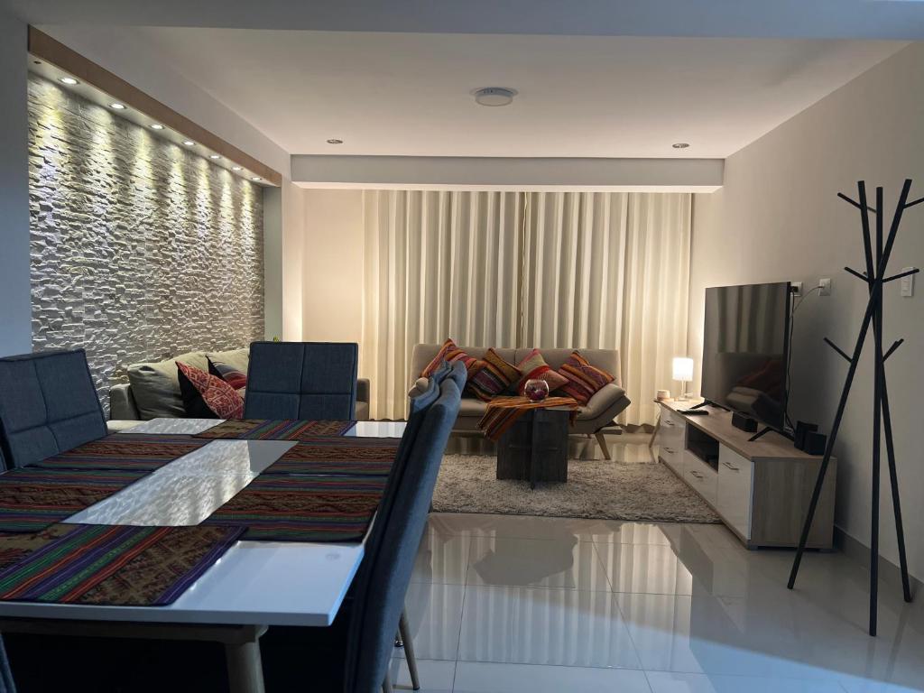 a living room with a table and a couch at Residencial Chávez Concha / Cusco in Cusco