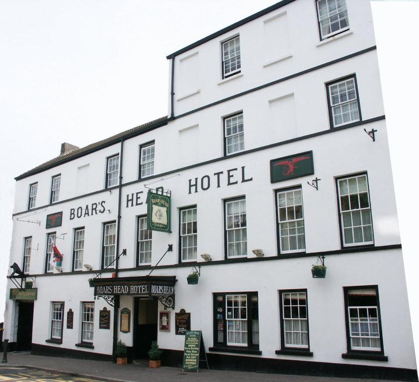a large building with a clock on the front of it at Boars Head Hotel in Carmarthen