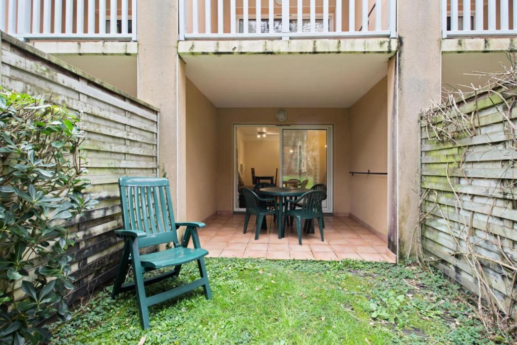 une terrasse avec une table et des chaises dans une maison dans l'établissement Le Domaine du Golf de Pinsolle - maeva Home - Appartement 2 Pièces 5 Personnes - Confort MAE-8890, à Soustons