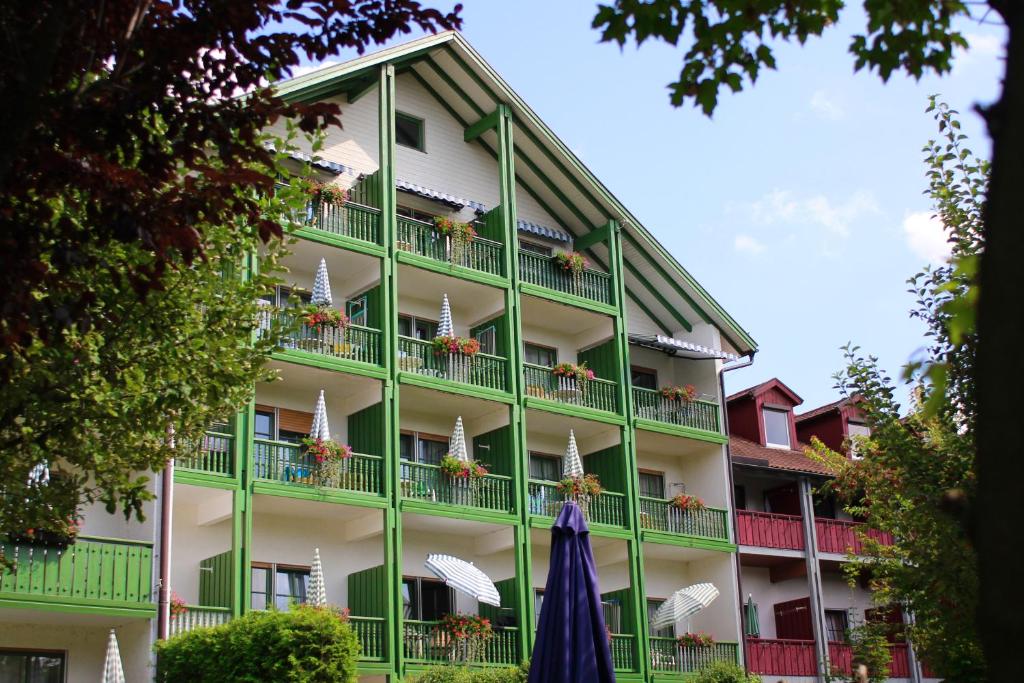 a green building with umbrellas in front of it at Sonnleiten-Rupert in Bad Griesbach
