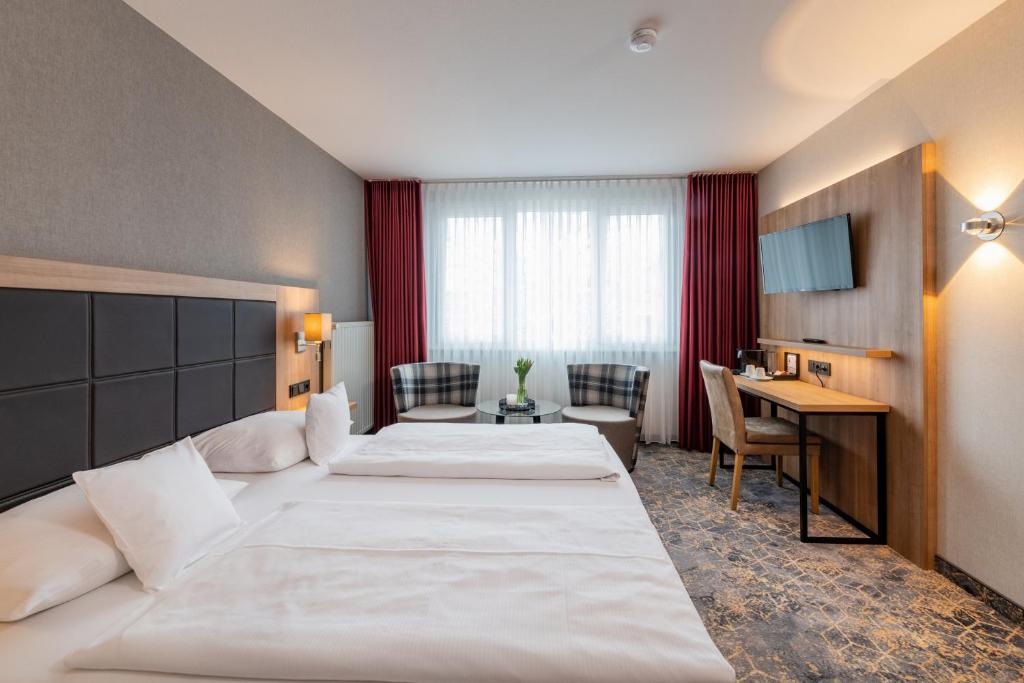 Postel nebo postele na pokoji v ubytování Göbel's Sophien Hotel
