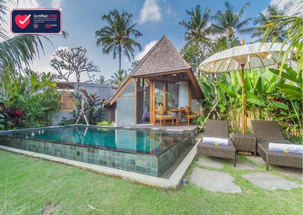 a swimming pool in front of a villa at Lasamana Villas Ubud by Pramana Villas in Ubud
