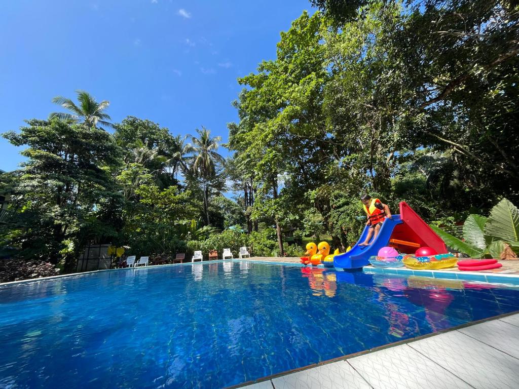 a pool with a water park with a water slide at Koh Mook Garden Beach Resort in Ko Mook