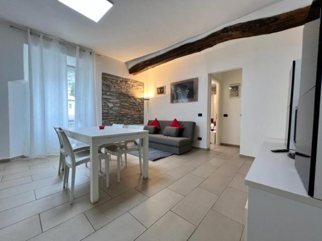 a kitchen and living room with a white table and chairs at Risveglio in Como
