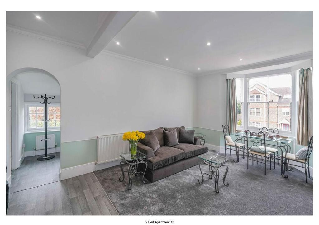 a living room with a couch and a table at The Park Apartment in Haywards Heath