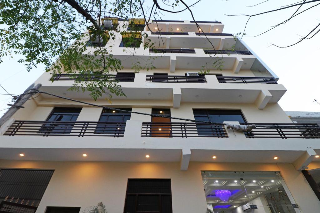 a white building with balconies on it at Hotel Airlift INN at Delhi Airport in New Delhi