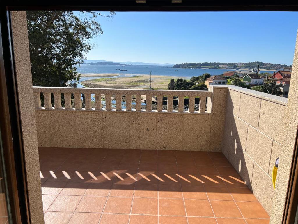 a balcony with a view of the ocean at El Nido in A Pobra do Caramiñal