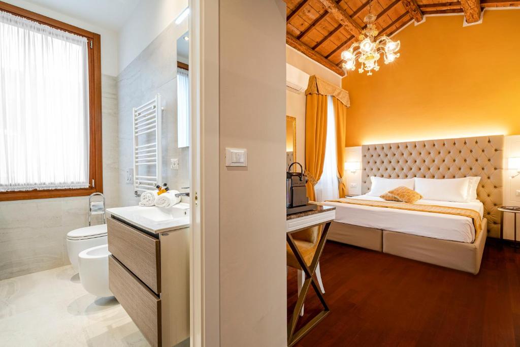 Posteľ alebo postele v izbe v ubytovaní Residenza La Duchessa Deluxe Rooms