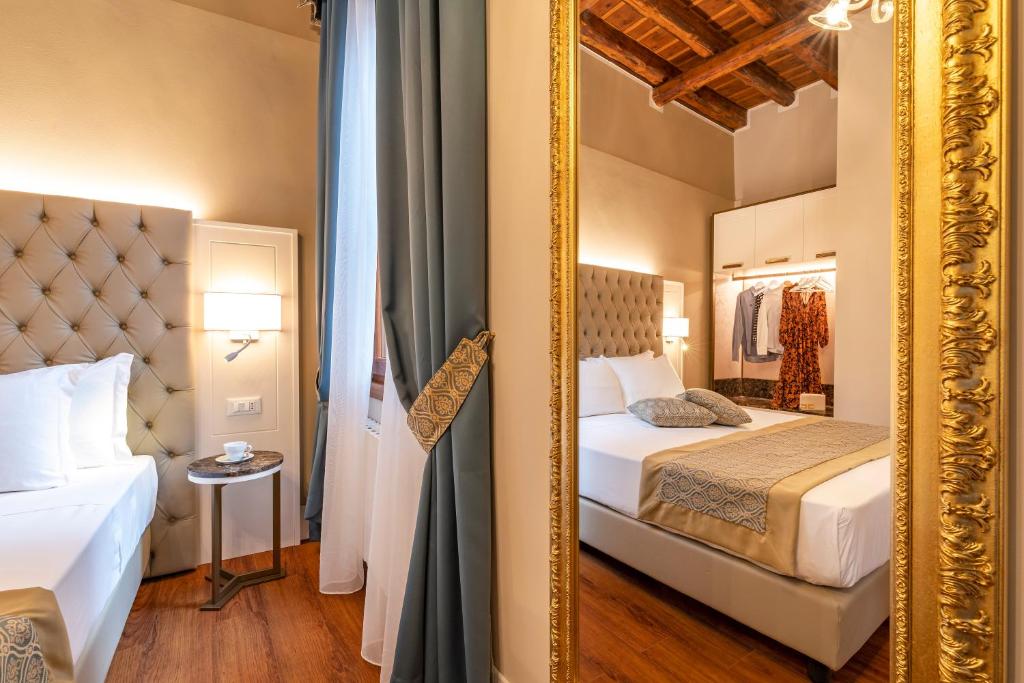 Posteľ alebo postele v izbe v ubytovaní Residenza La Duchessa Deluxe Rooms