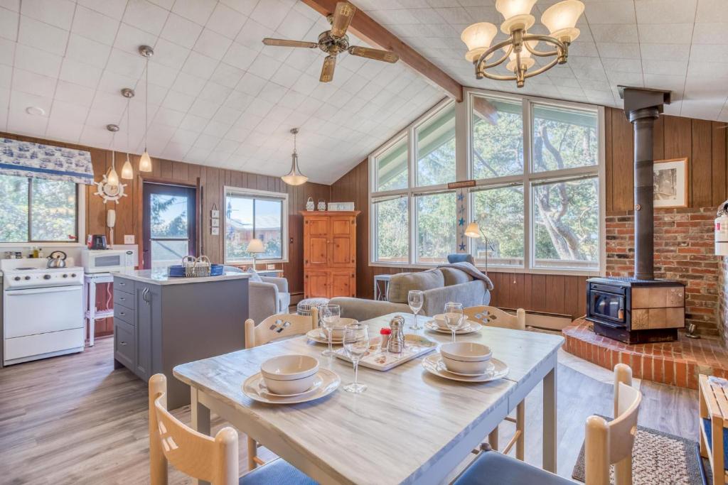 a kitchen and living room with a table and chairs at The Beach Cabin MCA 736 in Manzanita