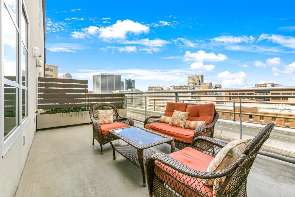 a balcony with furniture and a view of the city at Modern & Fully Furnished Apartments in the Heart of the City in New Orleans