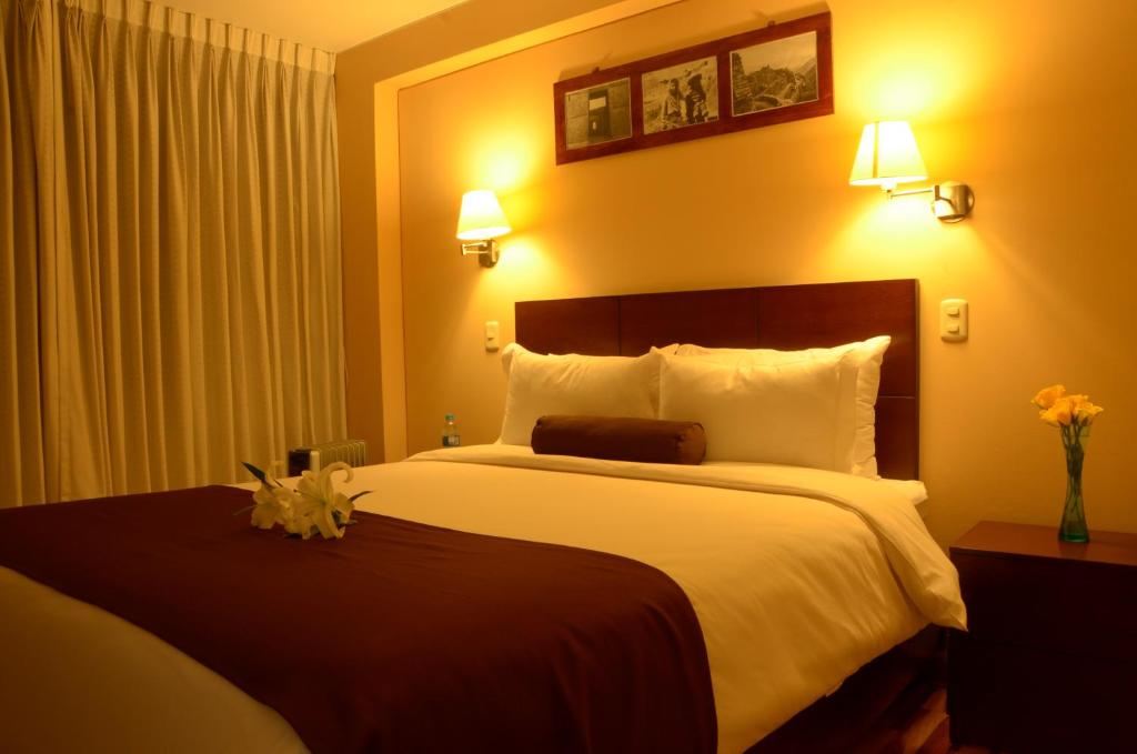 Postel nebo postele na pokoji v ubytování Kapac Inn Hotel