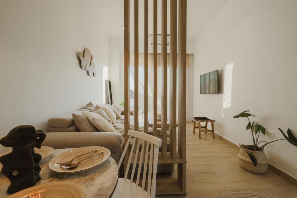 a living room with a couch and a table at Casa Costa Suites in Kanali