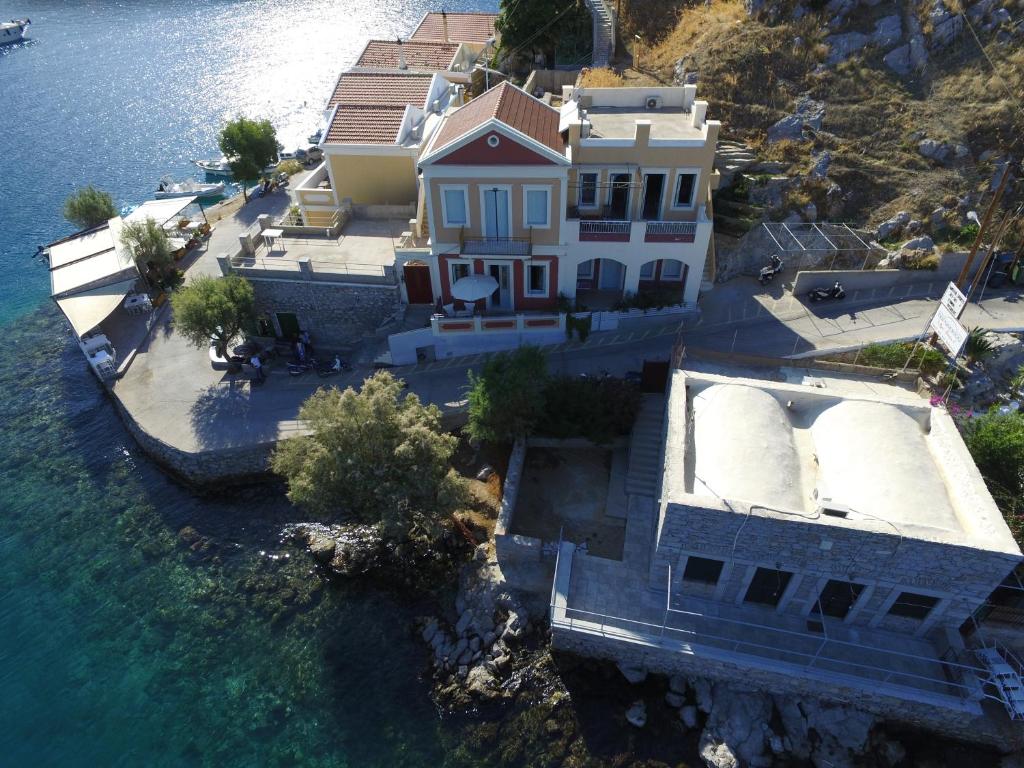 an aerial view of a house next to the water at anoi tholos in Symi