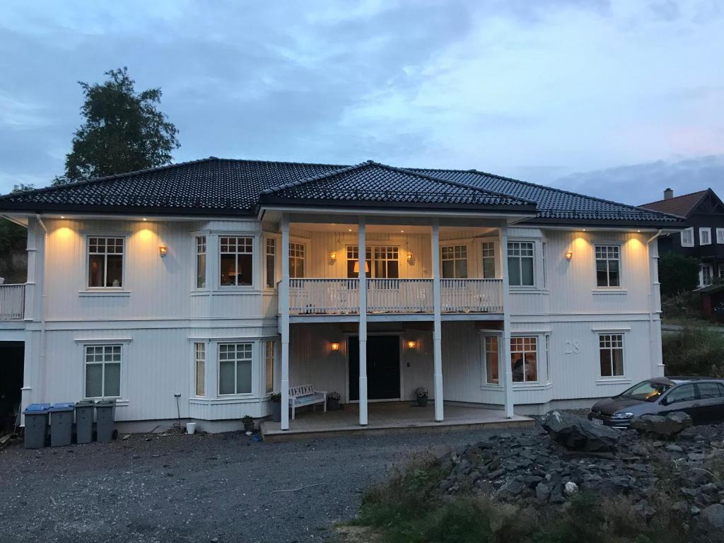 a large white house with a car parked in front of it at Villa Klæboe in Bergen