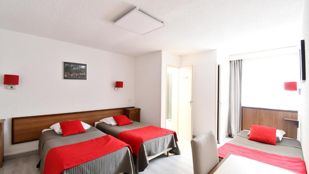 Postel nebo postele na pokoji v ubytování Hotel Fortin