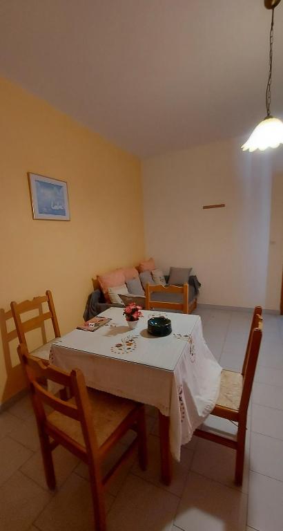 a living room with a table and chairs and a couch at Amaryllis Hotel in Karpathos