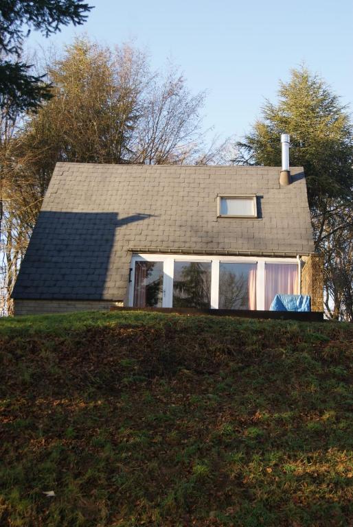 a house on top of a grassy hill at Terrasses de Malmedy Chalet 141 in Malmedy