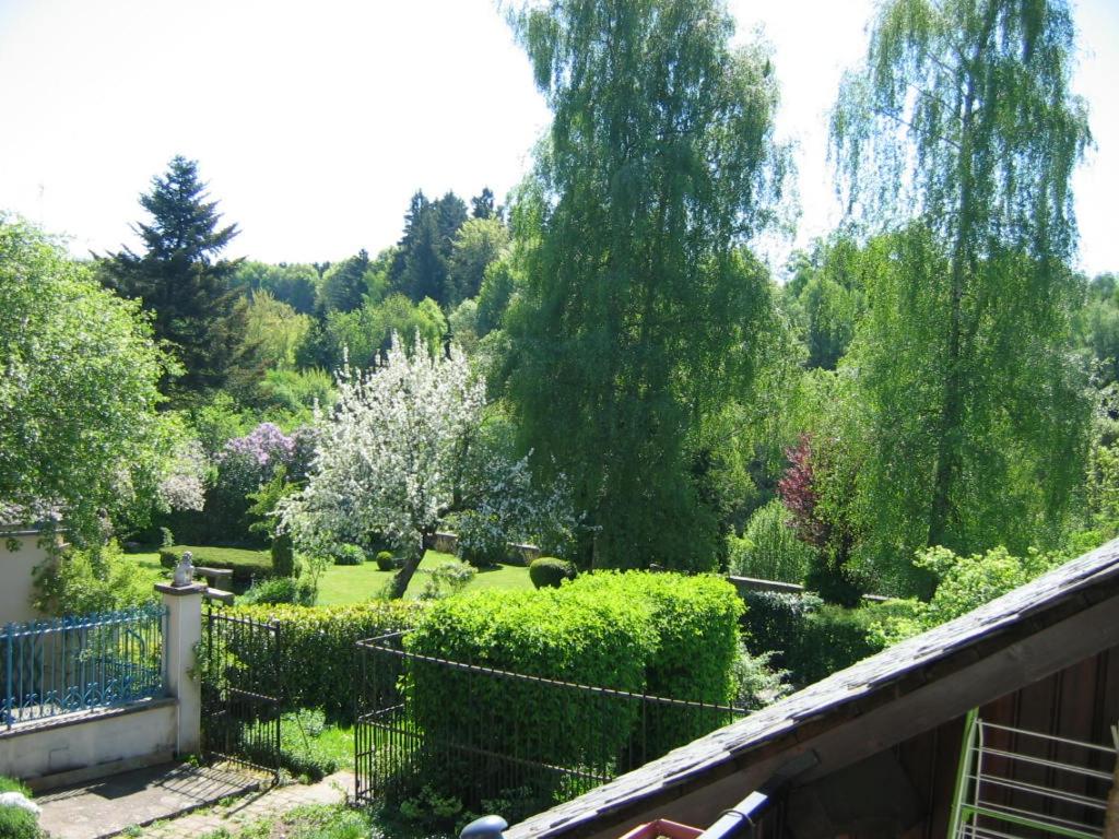a view of a garden from the balcony of a house at LES GITES D'AVEZE Volcan, Sancy, Bourboule in Avèze