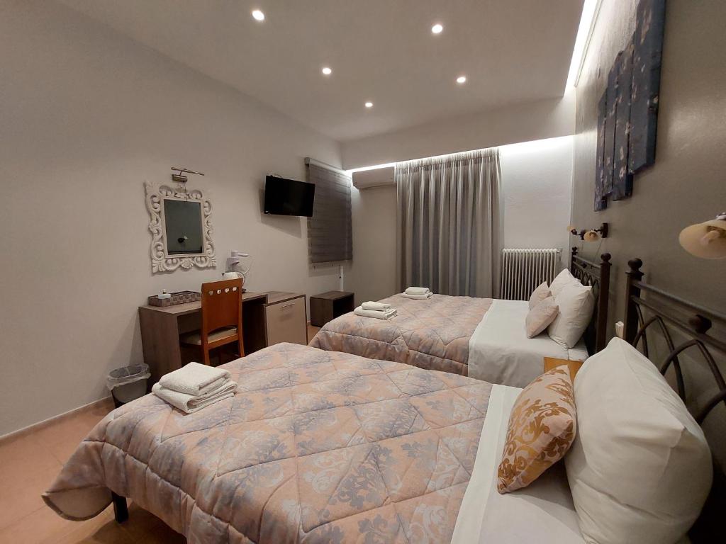 Postel nebo postele na pokoji v ubytování Hotel Akti
