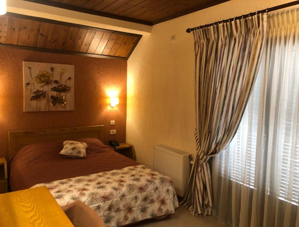 Postel nebo postele na pokoji v ubytování Asimina Guesthouse, Eptalofos Parnassos