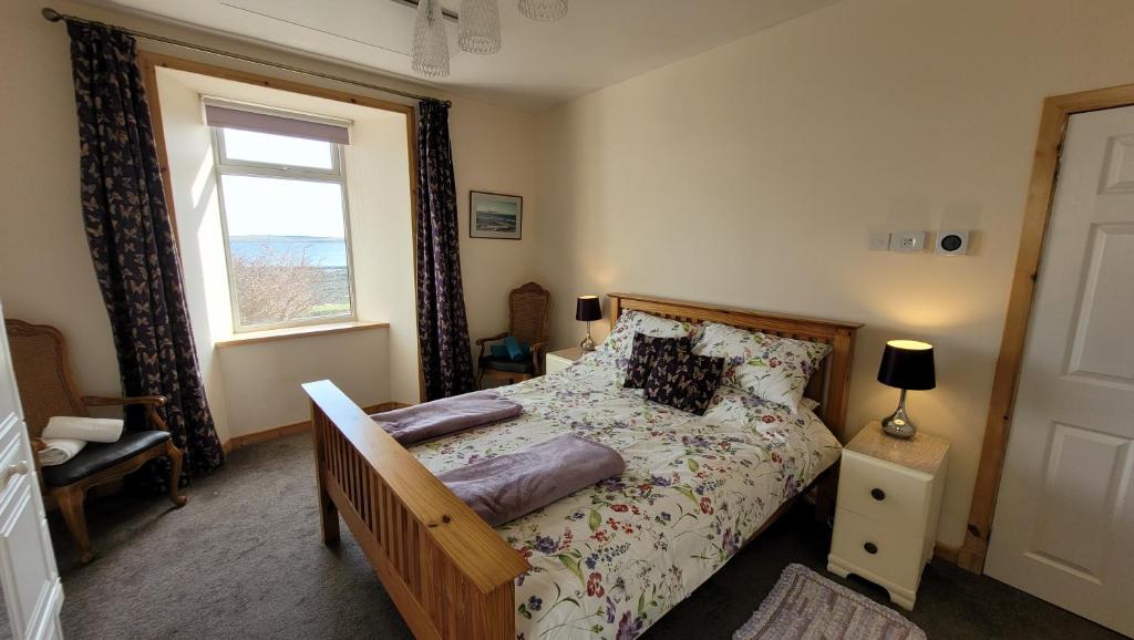 a bedroom with a bed and a window at Glenduron-by-Sea in Saint Marys