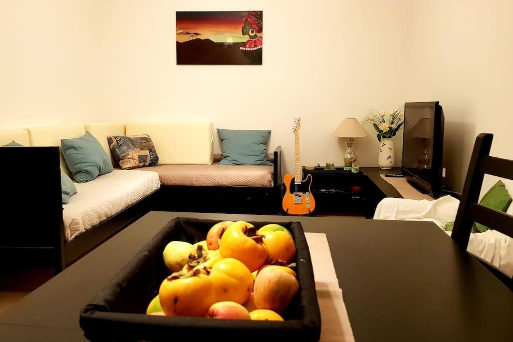 a living room with a bowl of fruit on a table at A casa di Rudy in Biancavilla