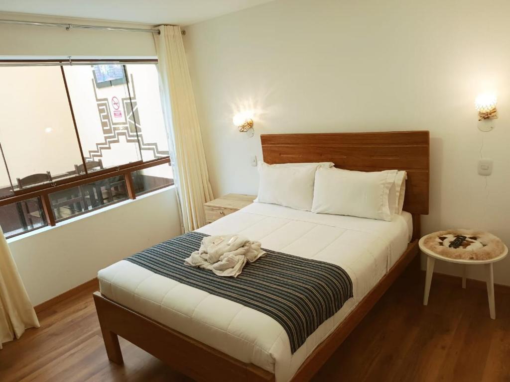 Postel nebo postele na pokoji v ubytování Cusco Hostal Qolla Wasi-II