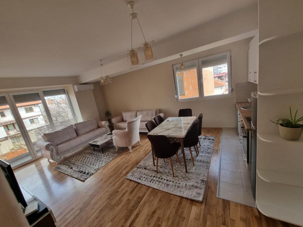 a living room with a table and a couch at Atena Apartment in Ohrid