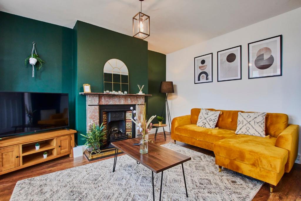 a living room with a couch and a fireplace at Stylish 2 Bedroom Flat - Close To Newcastle City Centre in Gateshead