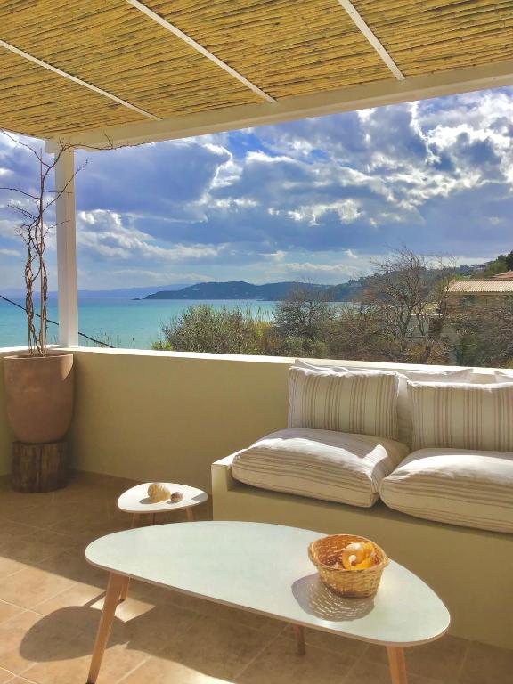a living room with a couch and a table at Villa Persephone in Megali Ammos