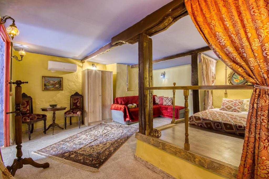 a bedroom with a bed and a living room at Fatma Hanoum boutique hotel in Rhodes Town