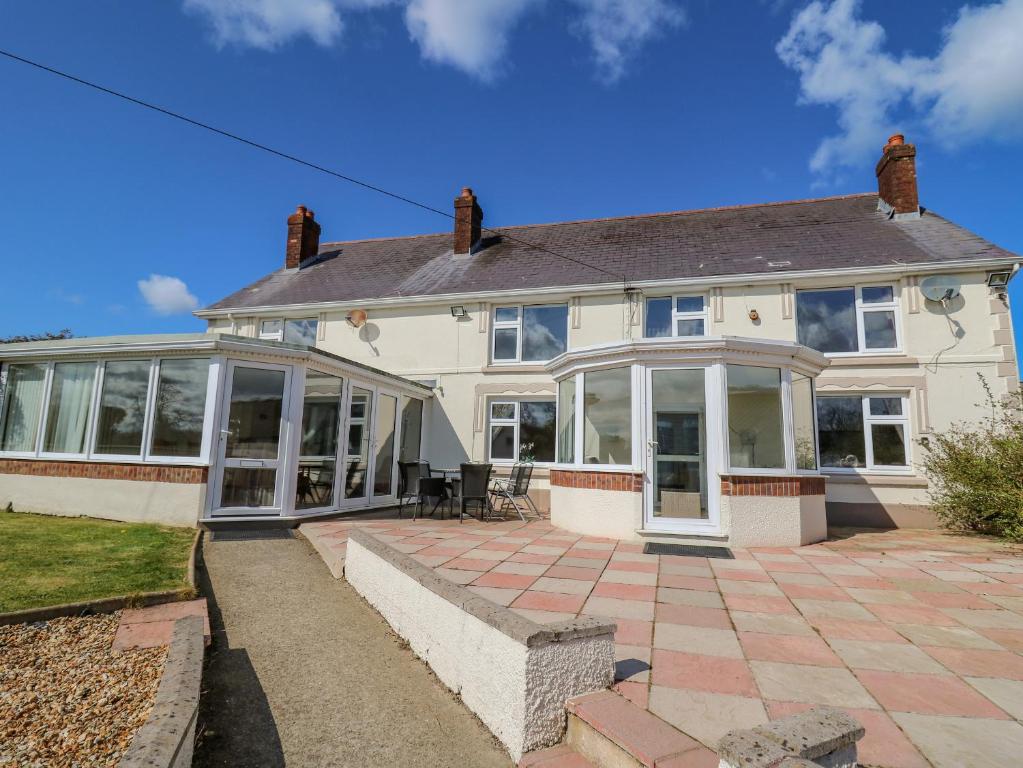 a large white house with large windows at Blaensilltyn in Bettws-Evan